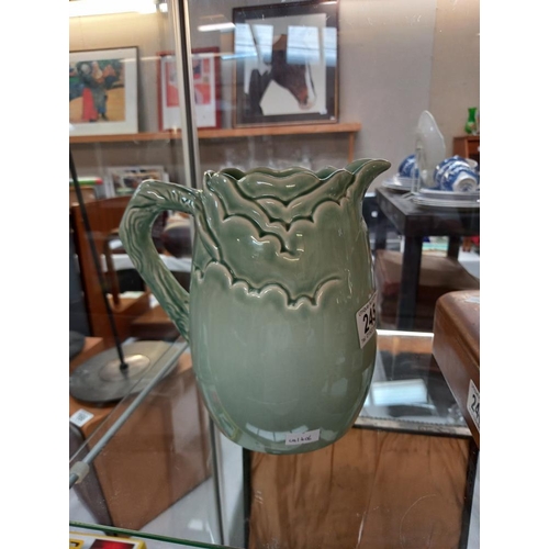 245 - A green glazed Clarice Cliff jug