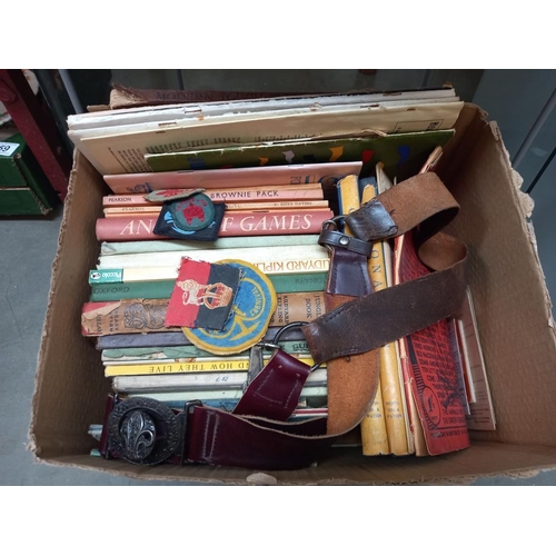 249 - A box of vintage scouting books, badges, belt and knives