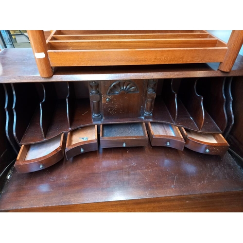 254 - A mahogany bureau with serpentine front COLLECT ONLY