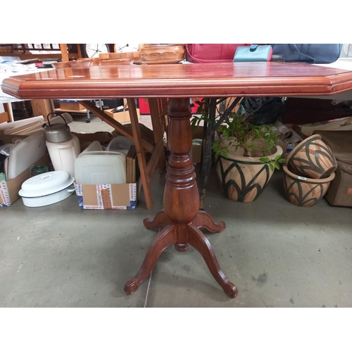 267 - A mahogany tea table with rectangular octagonal top on centre column with 4 legs COLLECT ONLY