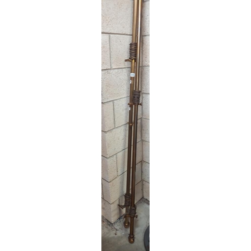 268 - 2 brass coloured curtain poles with rings, length 227cm and 287cm COLLECT ONLY