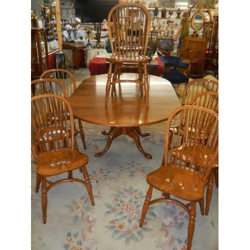 1570 - A good oak extending dining table with a set of 8 chairs with crinoline stretchers. COLLECT ONLY.