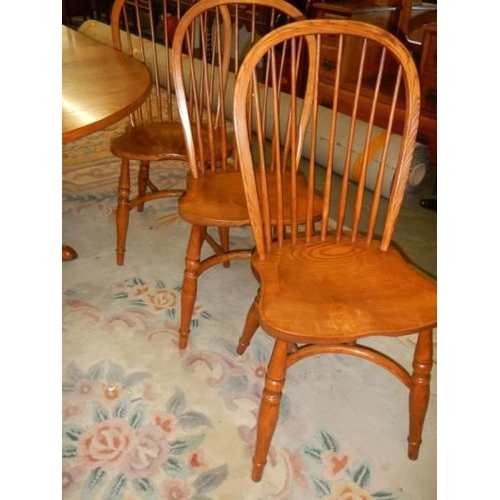 1570 - A good oak extending dining table with a set of 8 chairs with crinoline stretchers. COLLECT ONLY.