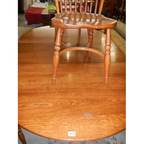 1570 - A good oak extending dining table with a set of 8 chairs with crinoline stretchers. COLLECT ONLY.