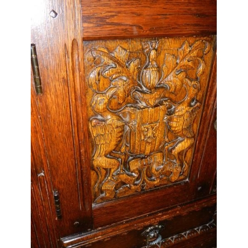 1572 - A heavily carved two door cabinet, COLLECT ONLY.