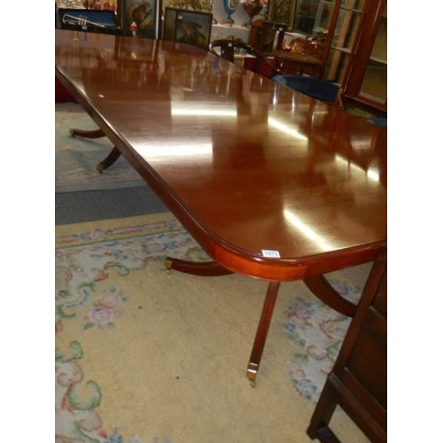 1573 - AN extending mahogany double pedestal dining table on splay feet, 305 cm long, COLLECT ONLY.