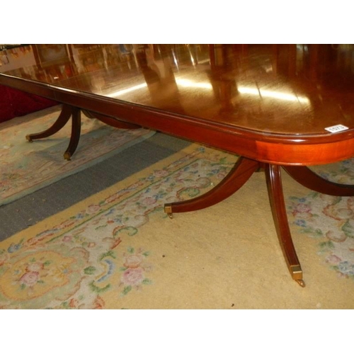 1573 - AN extending mahogany double pedestal dining table on splay feet, 305 cm long, COLLECT ONLY.