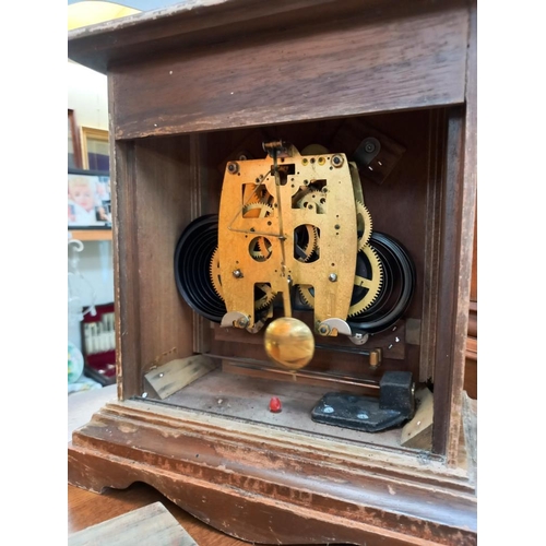 379 - An Edwardian oak mantle/bracket clock with silvered dial and a Trister 31 day mantle clock, all spri... 