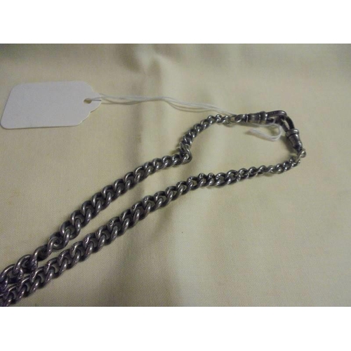 1007 - A silver Albert chain with fob and charms, 38.7 grams.