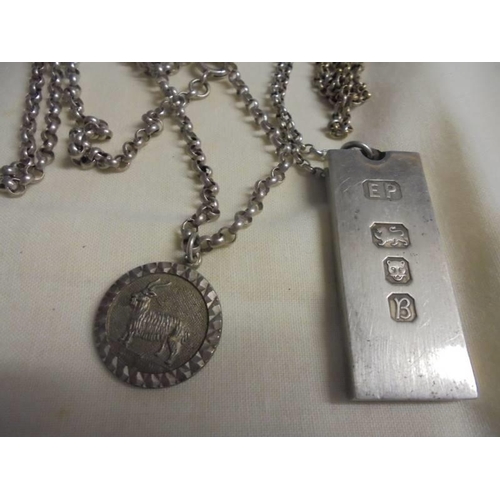 1008 - A silver ingot on a silver chain and a silver pendant on a silver chain, 54 grams.