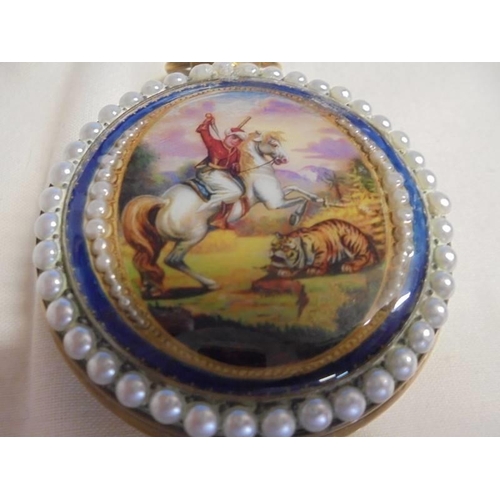 1023 - An ornate enamelled full hunter pocket watch in working order.