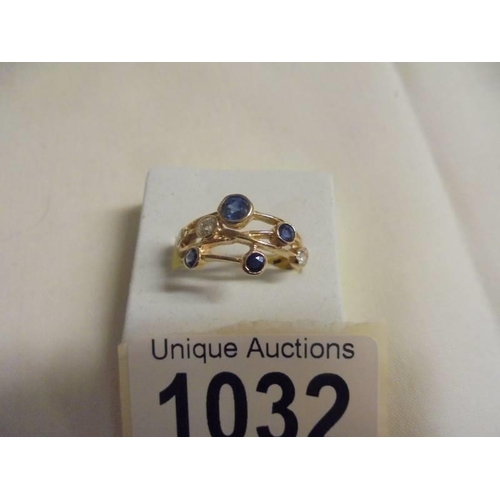 1032 - A Boodles style sapphire and diamond ring in yellow gold, size N, 3.2 grams.