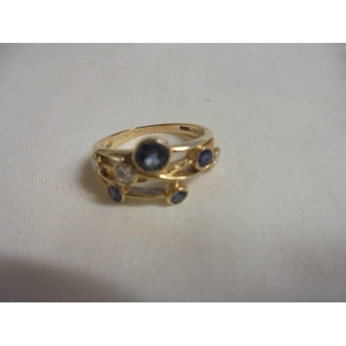 1032 - A Boodles style sapphire and diamond ring in yellow gold, size N, 3.2 grams.