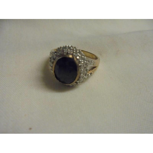 1037 - A large sapphire and diamond yellow gold ring, size O half, 4.93 grams.