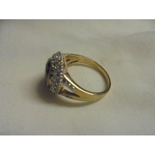 1037 - A large sapphire and diamond yellow gold ring, size O half, 4.93 grams.