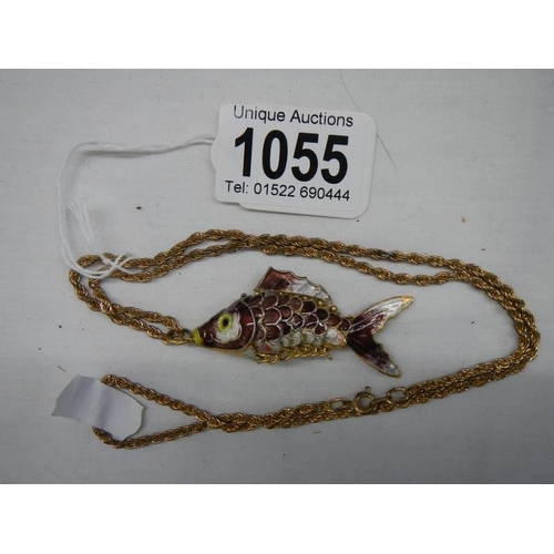 1055 - A mid 20th century enamel articulated fish pendant on yellow metal chain.