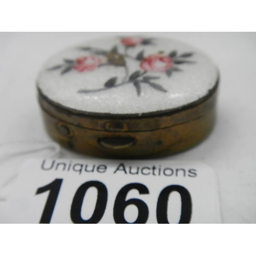 1060 - An early 20th century enamel and brass pill box.