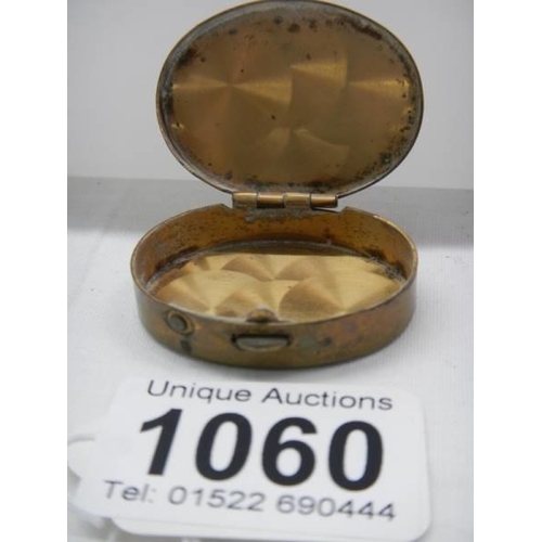 1060 - An early 20th century enamel and brass pill box.