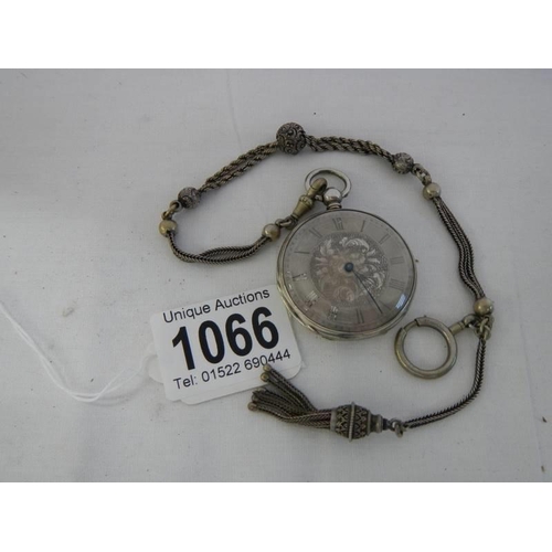 1066 - A Victorian chatelain chain together with a silver cased pocket watch.