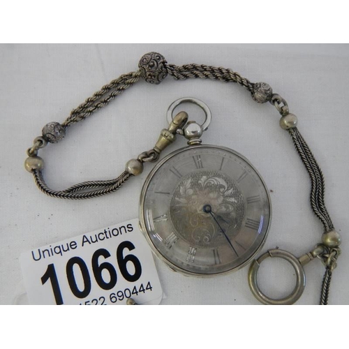 1066 - A Victorian chatelain chain together with a silver cased pocket watch.