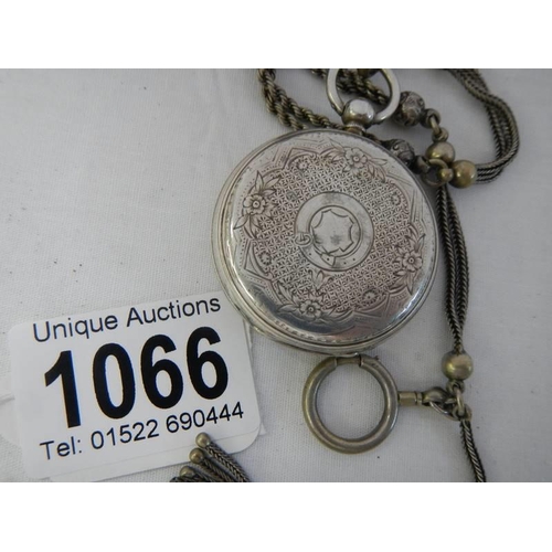 1066 - A Victorian chatelain chain together with a silver cased pocket watch.