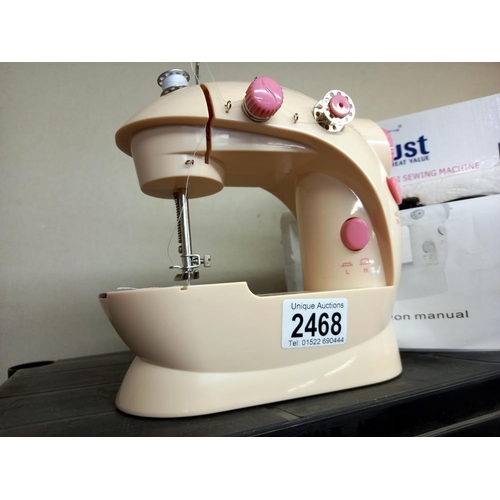 2468 - A boxed mini sewing machine