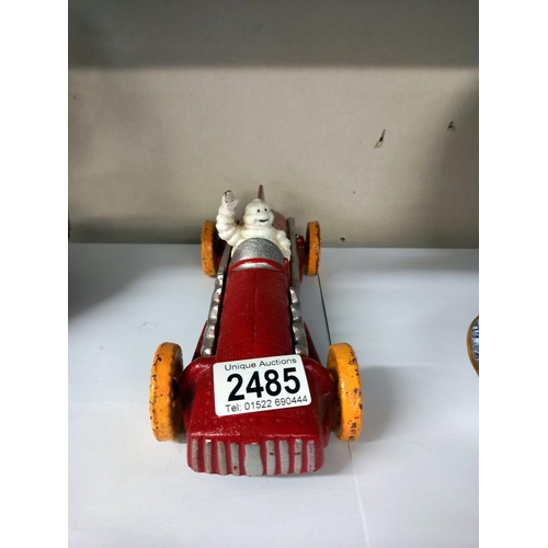 2485 - A cast iron Michelin man racing car in red