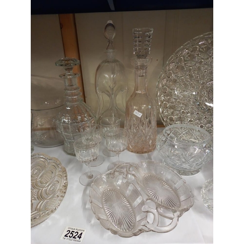 2524 - A shelf of glass including bowls & decanters etc. COLLECT ONLY