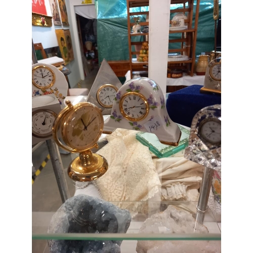 2554 - A selection of miniature decorative clocks including pewter, Edinburgh Crystal etc.