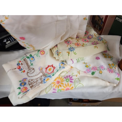 2570 - A quantity of vintage embroidered tablecloths