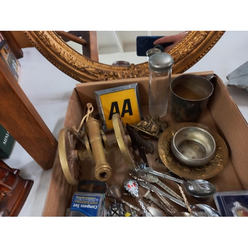 2574 - A tray of metalware including tourist spoons, brass cannon & AA badge etc.