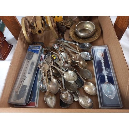 2574 - A tray of metalware including tourist spoons, brass cannon & AA badge etc.