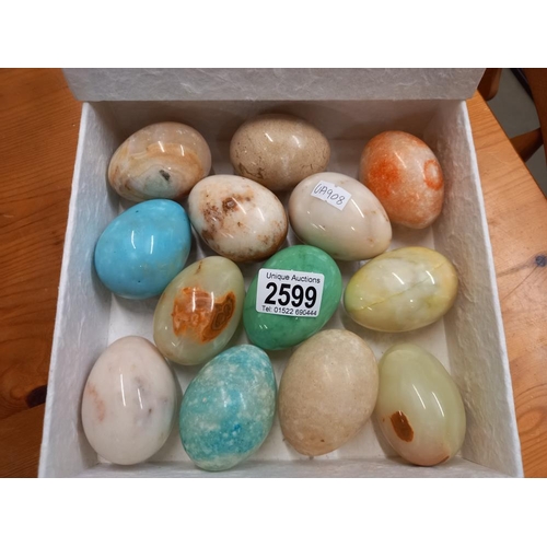 2599 - A box of polished stone egg hand coolers