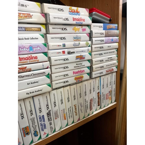 2645 - A quantity of DS Consoles and over 140 games (boxed and unboxed) Collect Only