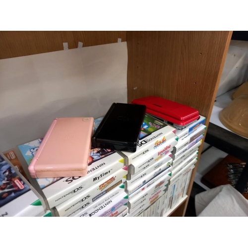 2645 - A quantity of DS Consoles and over 140 games (boxed and unboxed) Collect Only