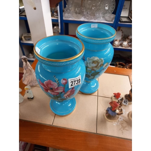 2739 - A pair of Victorian blue glass vases with overlaid painted flowers