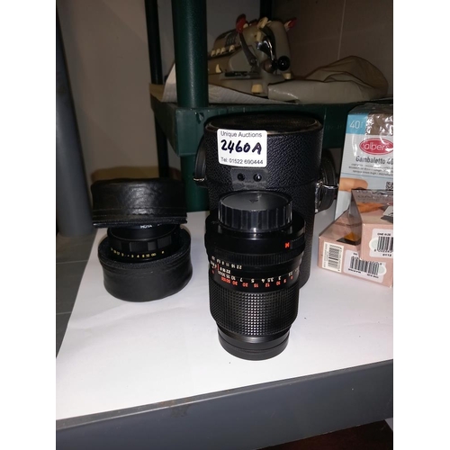 2460A - 2 cased camera zoom lenses (one being a Hoya skylight)