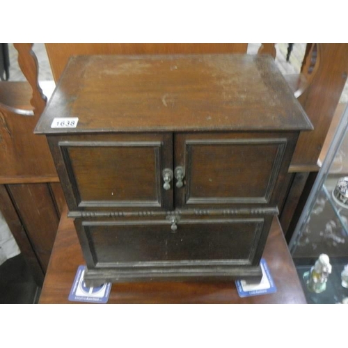 1638 - A 1930's oak cabinet with two doors, removable bolt-on front panel and lift up lid,  43 X 29 X 46 cm... 