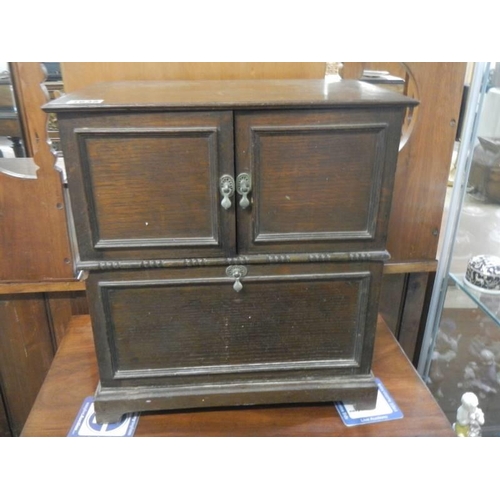 1638 - A 1930's oak cabinet with two doors, removable bolt-on front panel and lift up lid,  43 X 29 X 46 cm... 