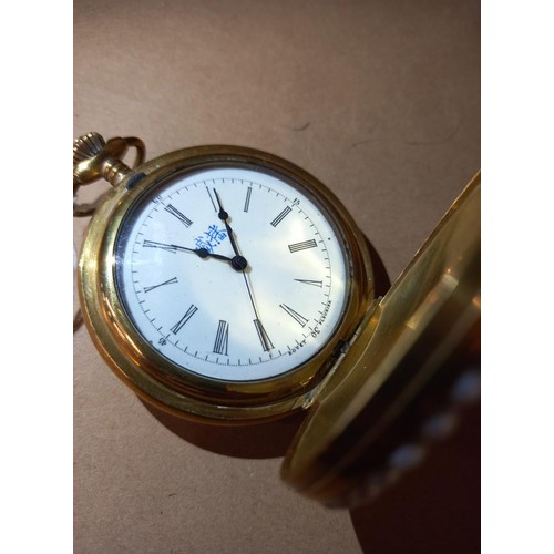 1023 - An ornate enamelled full hunter pocket watch in working order.