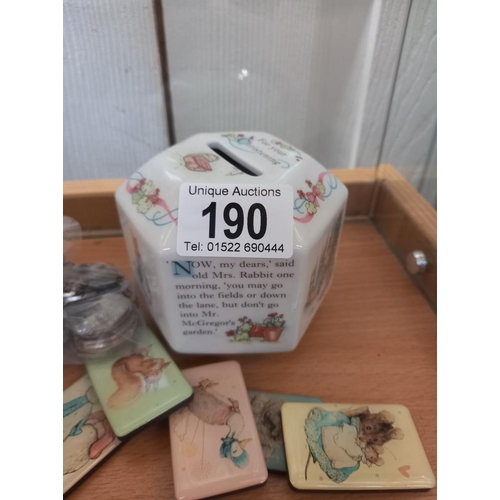 190 - A quantity of Beatrix Potter 50p coins (approximately £11.50) 2 money boxes and magnets