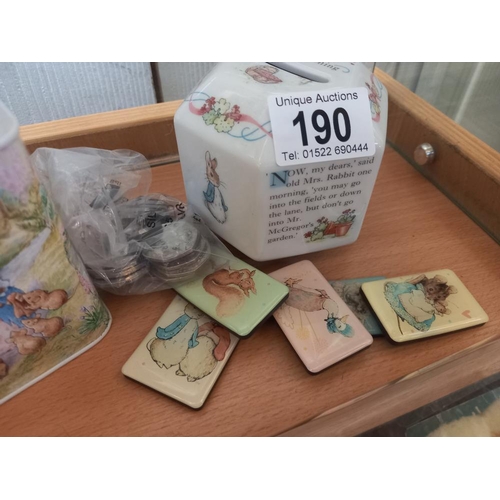 190 - A quantity of Beatrix Potter 50p coins (approximately £11.50) 2 money boxes and magnets