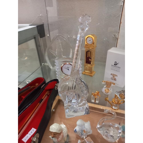 197 - A quantity of crystal glass ornaments including Swarovski, a banjo plus a small violin in case