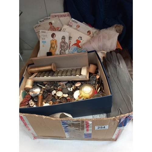 254 - A box of linen, sewing items, buttons, sewing patterns & gloves etc. COLLECT ONLY