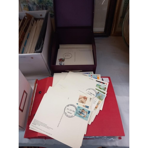 263 - A large quantity of first day covers in boxes & an album COLLECT ONLY