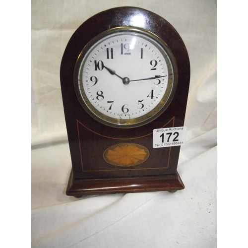 172 - A small French enamel faced clock with key (enamel slightly a/f)