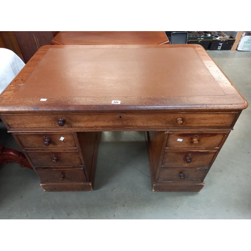 326 - An oak pedestal writing desk with brown leatherette top. COLLECT ONLY.