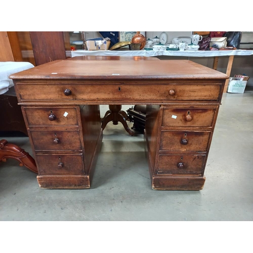 326 - An oak pedestal writing desk with brown leatherette top. COLLECT ONLY.