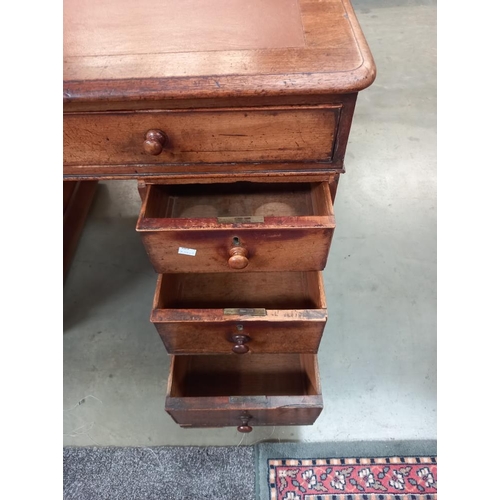 326 - An oak pedestal writing desk with brown leatherette top. COLLECT ONLY.