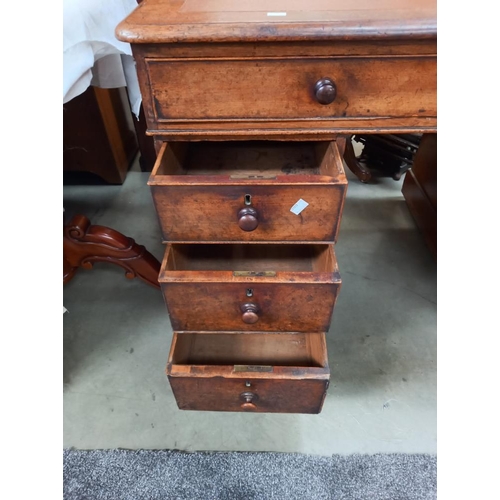 326 - An oak pedestal writing desk with brown leatherette top. COLLECT ONLY.